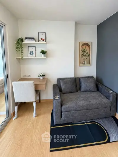 Modern living room with stylish gray sofa and compact workspace
