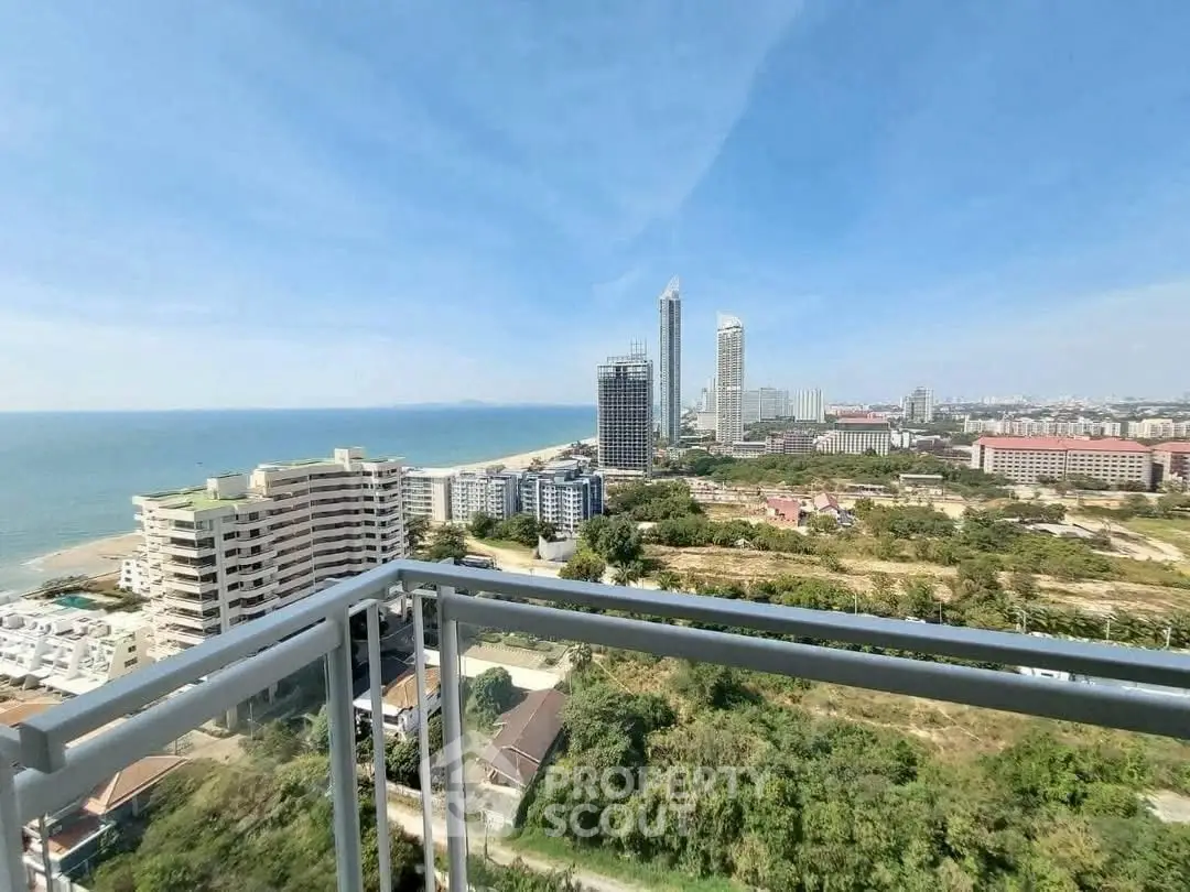 Stunning high-rise balcony view overlooking cityscape and ocean horizon.