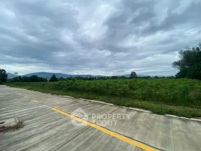 Expansive land plot with scenic mountain views and lush greenery, perfect for development opportunities.