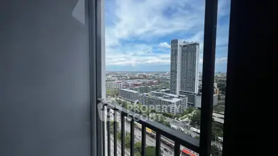 Stunning high-rise apartment view with cityscape and ocean horizon, perfect for urban living.