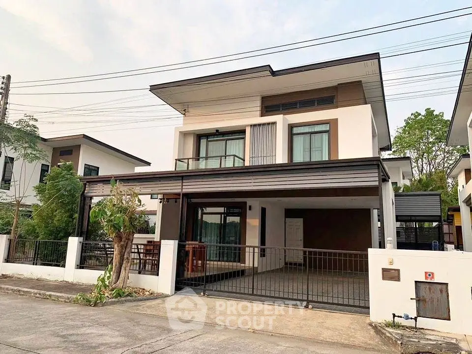 Modern two-story house with spacious driveway and contemporary design.
