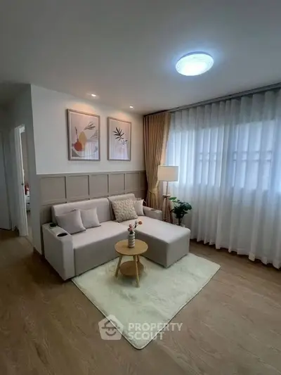 Charming living room with cozy sofa, elegant decor, and natural light for a serene ambiance.