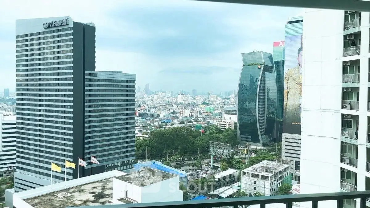 Stunning cityscape view from high-rise building balcony in vibrant urban area.