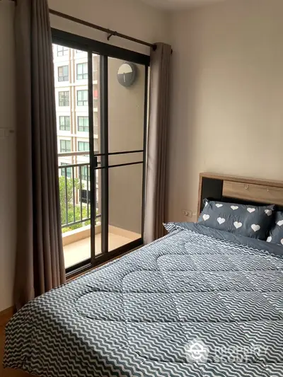 Cozy bedroom with balcony access in modern apartment