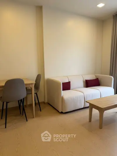 Modern living room with cozy sofa and dining area in a stylish apartment.