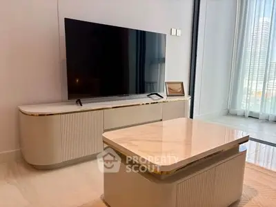 Modern living room with sleek TV stand and marble coffee table, featuring floor-to-ceiling windows.