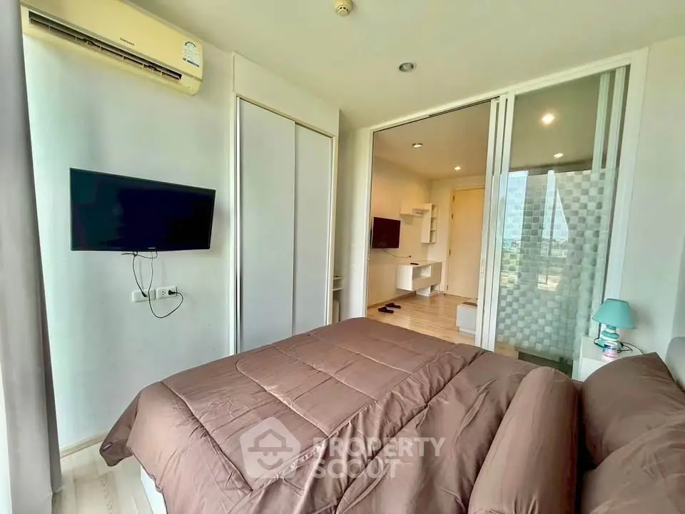 Modern bedroom with TV and air conditioning in a stylish apartment