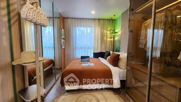Cozy bedroom with modern decor, mirrored wardrobe, and warm lighting, perfect for relaxation.