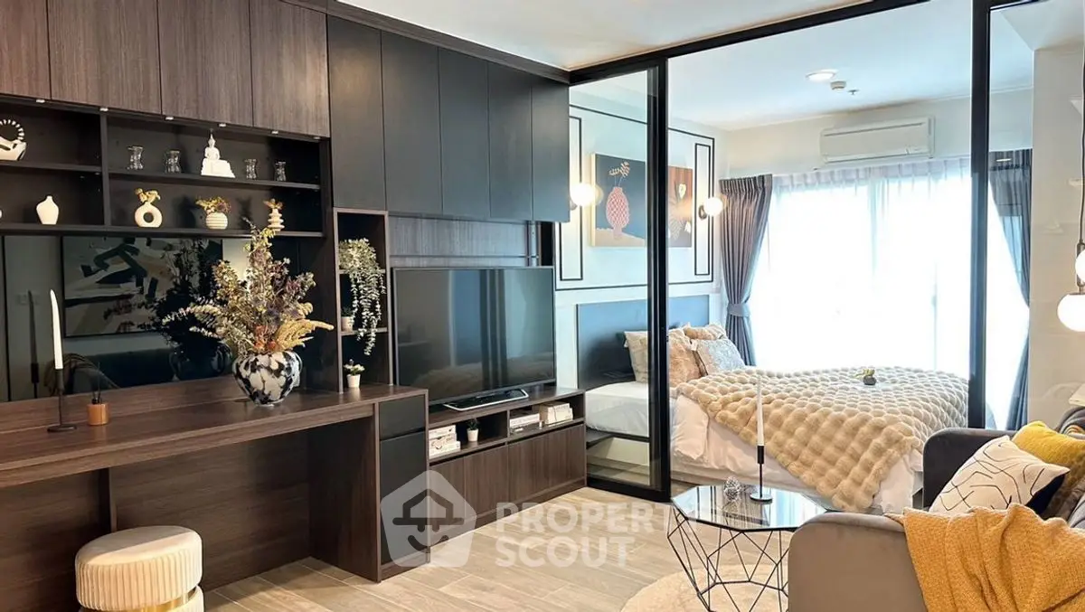 Modern open-plan living room with stylish decor and bedroom view