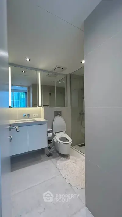 Modern bathroom with sleek fixtures and glass shower enclosure