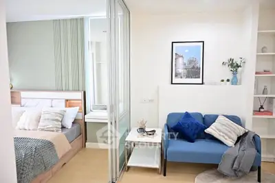 Modern studio apartment with cozy living area and stylish bedroom, featuring elegant decor and smart space utilization.
