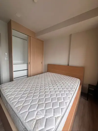 Cozy bedroom with wooden wardrobe and comfortable mattress, perfect for restful nights.
