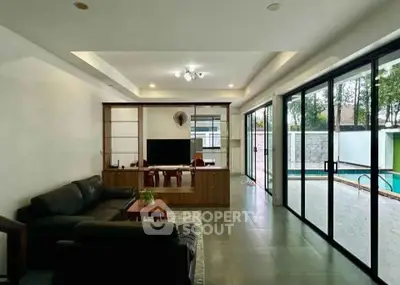 Spacious living room with pool view and modern decor