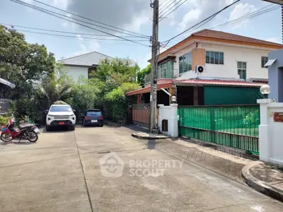 Charming suburban house with spacious driveway and lush greenery, perfect for family living.