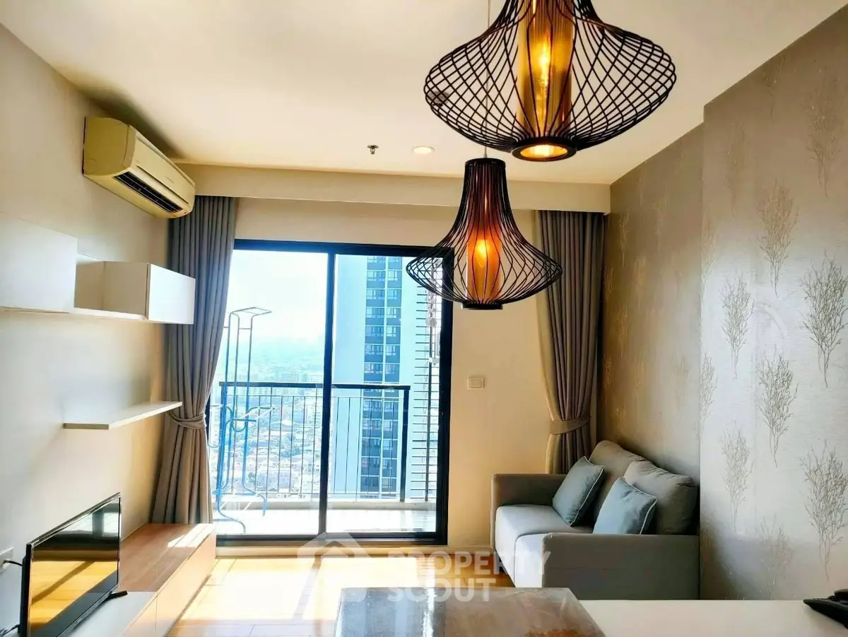 Modern living room with stylish lighting and balcony view in high-rise apartment.