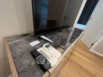 Modern living room with sleek TV setup on elegant marble console.