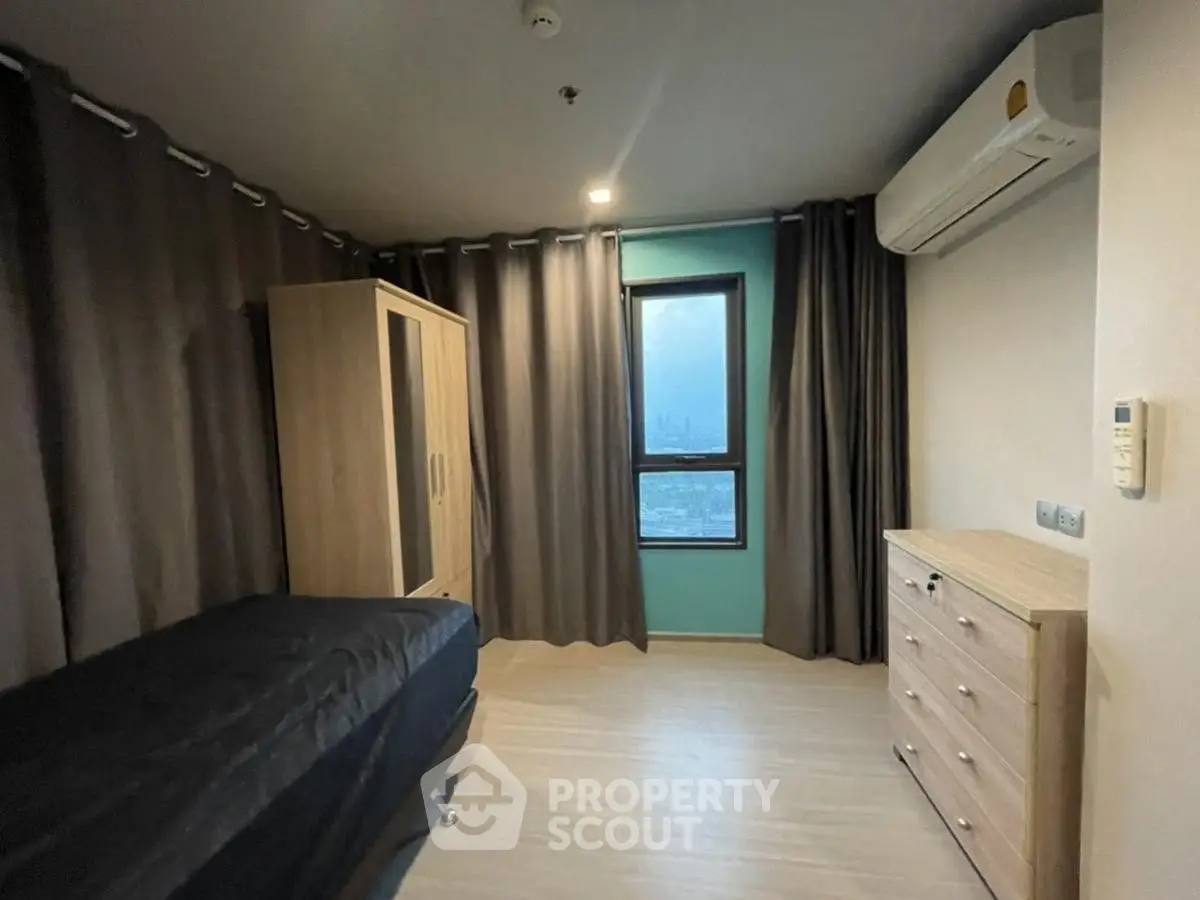 Modern bedroom with sleek furniture and city view window