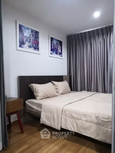 Cozy bedroom with modern decor and elegant curtains, perfect for relaxation.