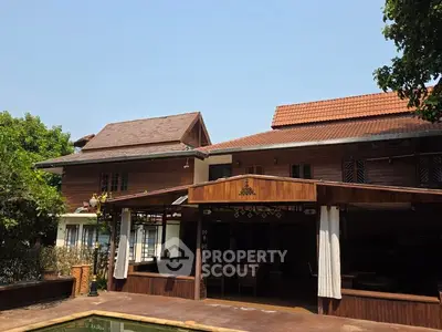 Charming traditional wooden house with spacious outdoor area and pool.