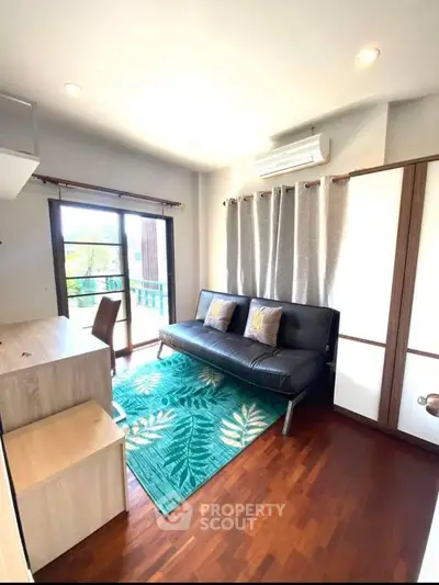 Bright living room with modern decor and balcony access