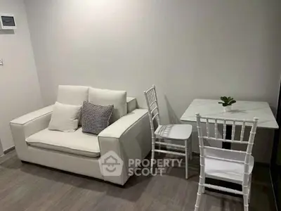 Cozy living room with white sofa and dining set, perfect for modern minimalist living.