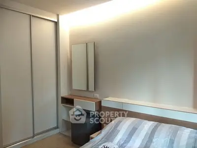 Modern bedroom with sleek sliding closet doors and stylish decor