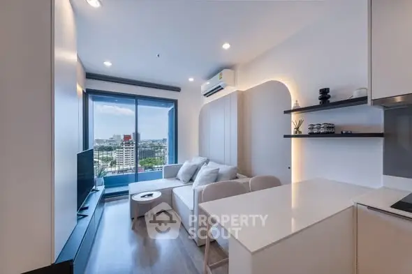 Modern living room with city view, sleek furniture, and open layout in a high-rise apartment.