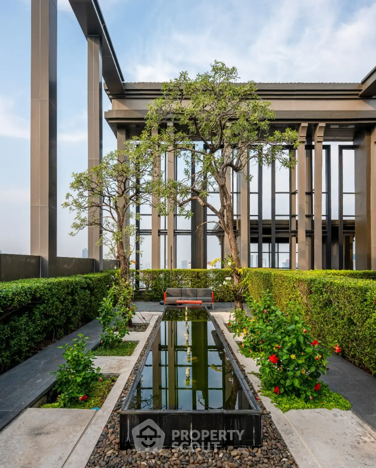 Luxurious rooftop garden with modern architectural design and serene water feature.