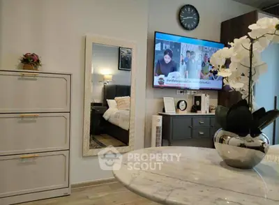 Modern living room with stylish decor and wall-mounted TV