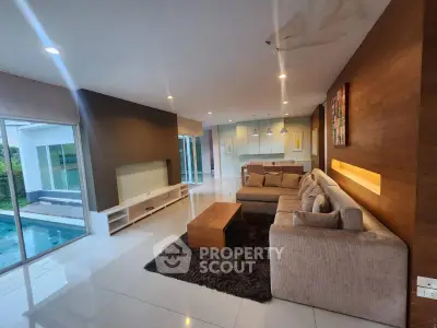 Spacious modern living room with pool view and elegant decor