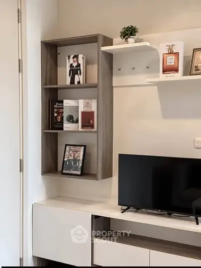 Modern living room with stylish shelving and flat-screen TV, perfect for contemporary urban living.