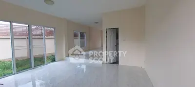 Spacious modern living room with large windows and marble flooring