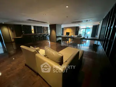 Spacious modern living room with elegant wooden flooring and stylish furniture, perfect for entertaining.