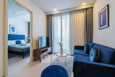 Modern living room with blue sofa and bedroom view in stylish apartment