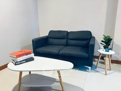 Modern living room with stylish sofa and coffee tables, perfect for cozy relaxation.