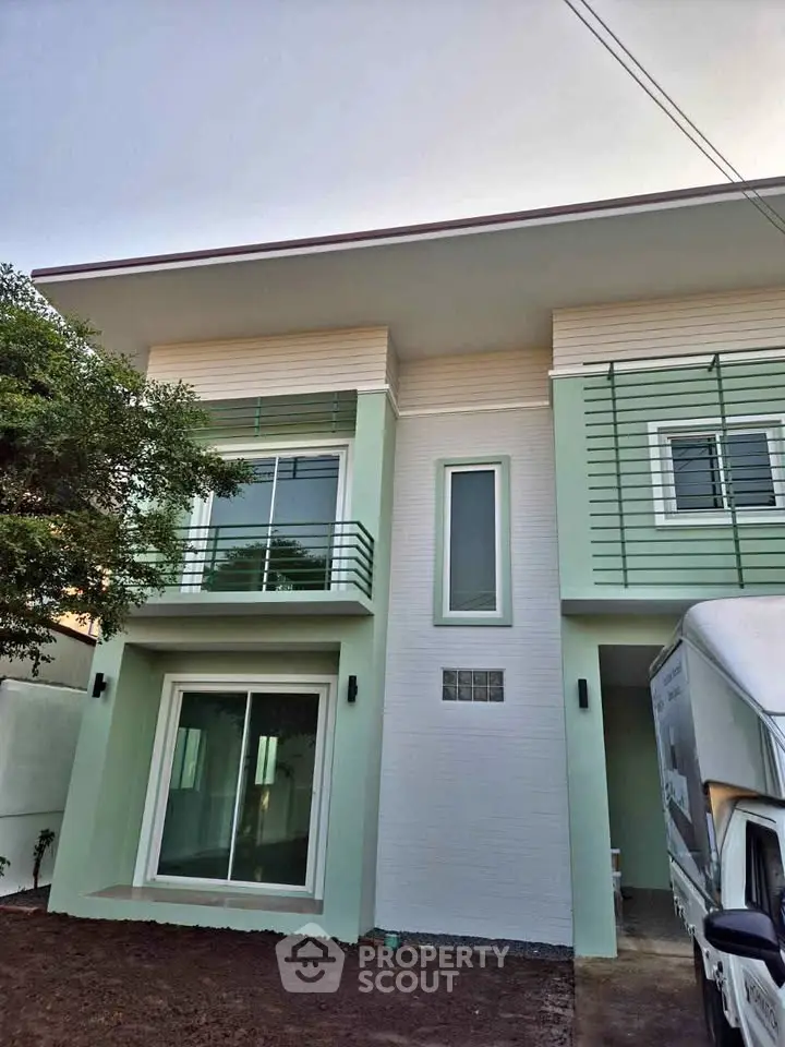 Modern two-story house with sleek design and large windows, perfect for contemporary living.