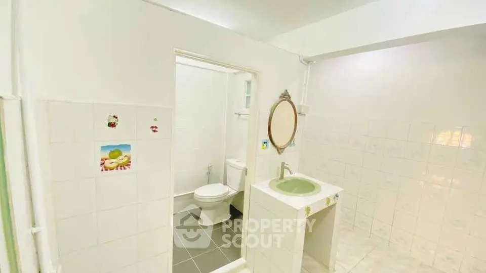 Spacious bathroom with unique tile design and modern fixtures.
