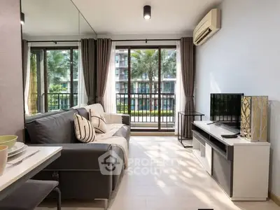 Modern living room with large windows and stylish decor in a high-rise apartment.