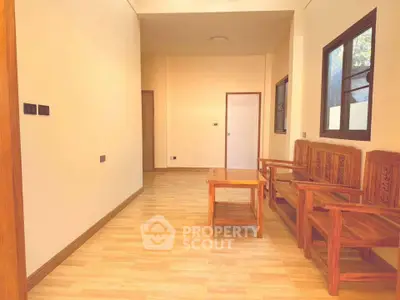 Spacious living area with wooden furniture and natural light