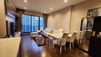 Spacious modern living room with elegant dining area and city view balcony.