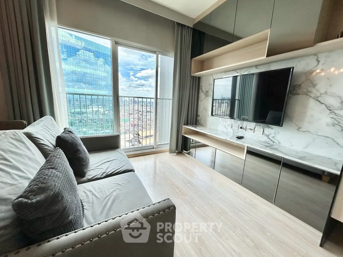 Modern living room with city view, sleek furniture, and large TV setup.