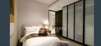 Modern bedroom with sleek design and sliding closet doors, perfect for urban living.