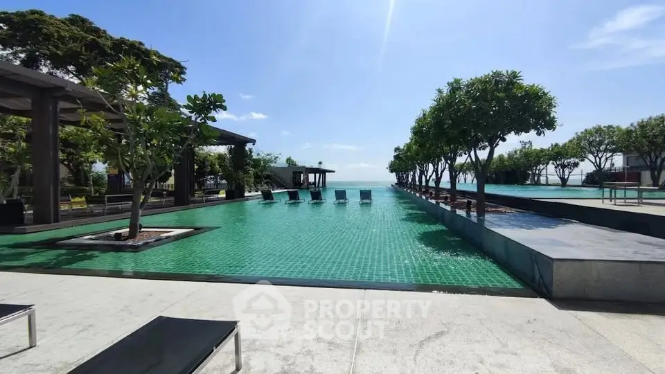 Luxurious rooftop pool with stunning ocean view and lush greenery