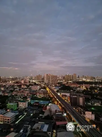 Stunning cityscape view from high-rise apartment at dusk with vibrant skyline.