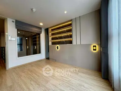 Modern living room with stylish lighting and wooden flooring
