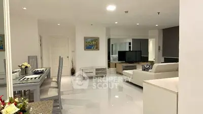 Spacious modern living room with elegant dining area and sleek furnishings.