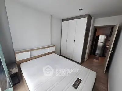 Modern bedroom with sleek wardrobe and cozy bed in stylish apartment.