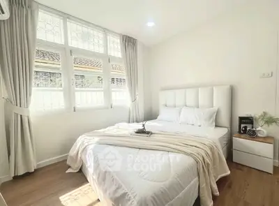 Bright and cozy bedroom with large window and elegant decor