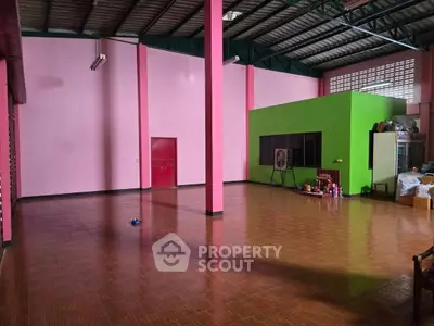Spacious open interior with colorful walls and tiled flooring, ideal for creative renovation.