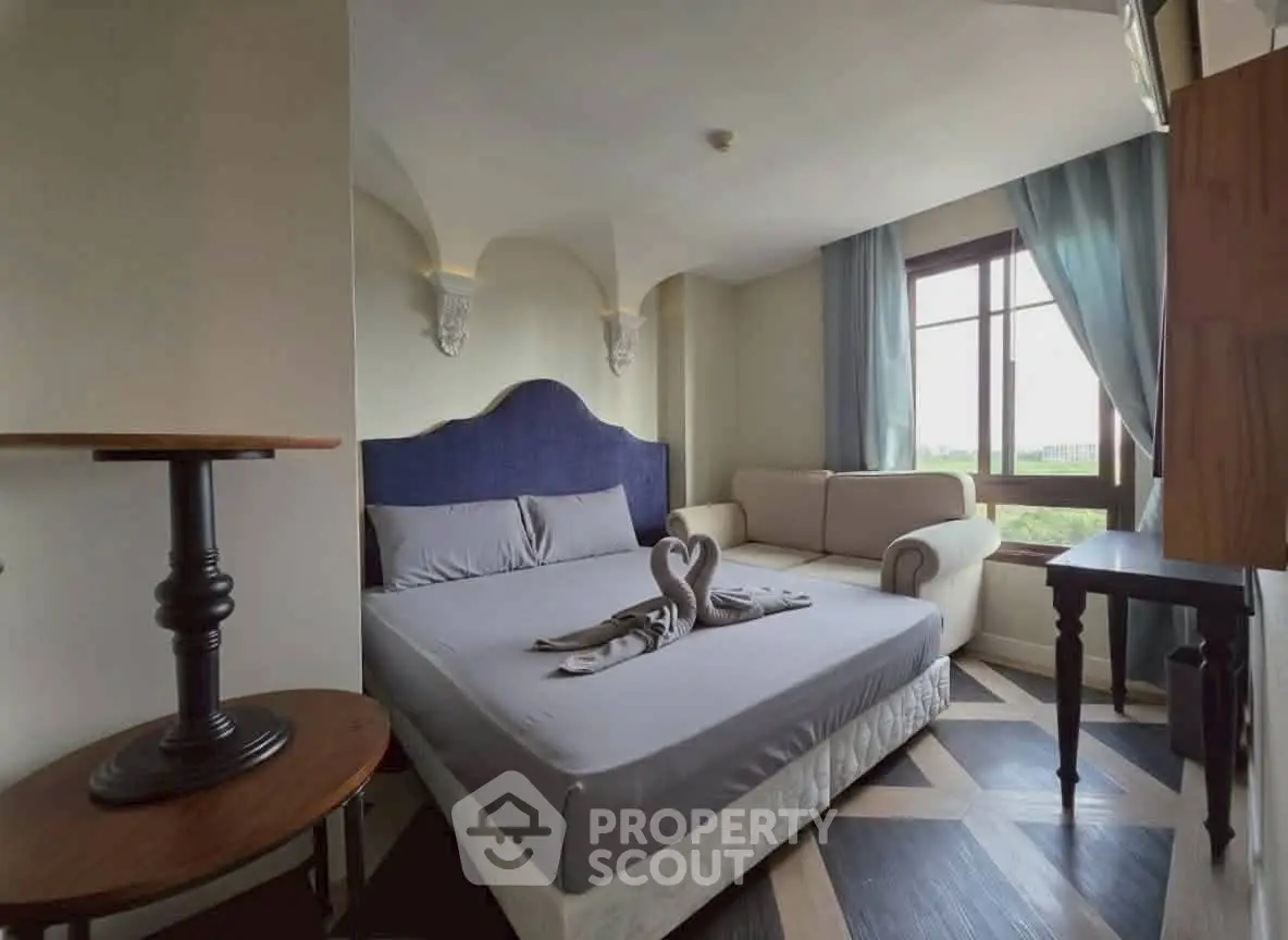 Charming bedroom with elegant decor and natural light, perfect for relaxation.